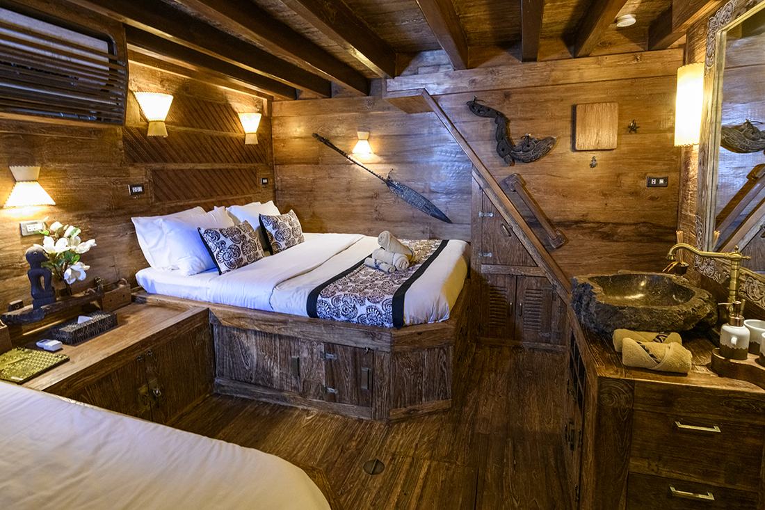 One of the below deck cabins (Legong cabin). These cabins are surprisingly large with a Queen-sized bed to one side and a single twin bed on the other, plus a vanity with a stone sink basin. All this with plenty of room between them to move about.