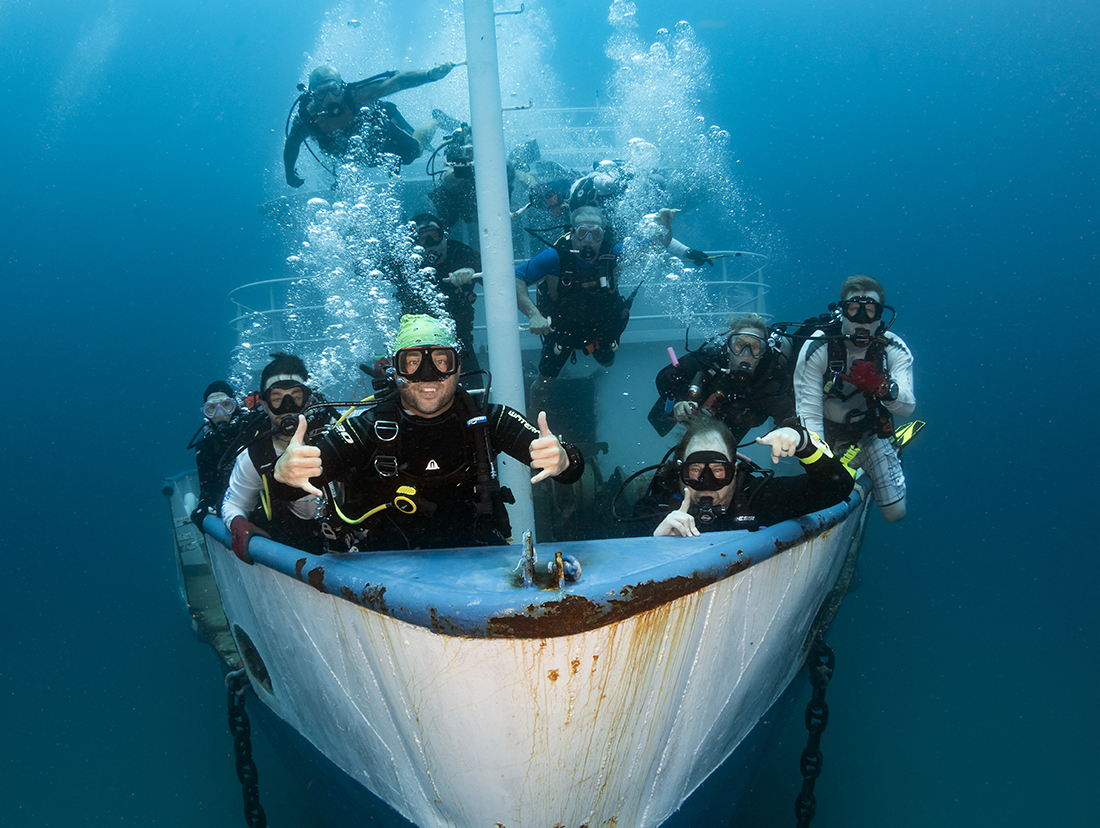 Divers on a brand-new wreck: While it might be convenient to hold onto something on the reef, it is advisable to Stay off the Bottom! Yeah right! As far as this brand new wreck that was just placed on the bottom. One of my most important tips give models and fellow photographers is don’t get too caught up in trying for perfection in the shot as it will take the fun out of the dive.