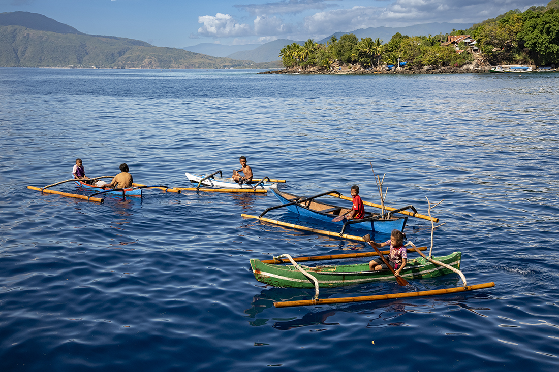 Children in their outrigger canoes at Marisa and Alor. Island